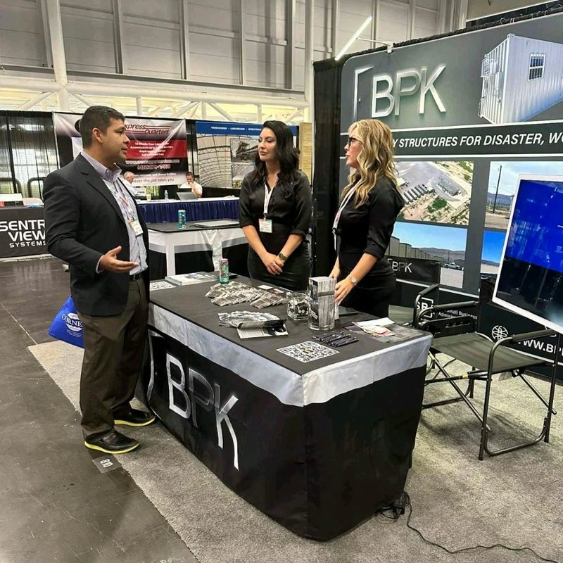 Christine and Bethany speaking with a prospect at the BPK trade show booth