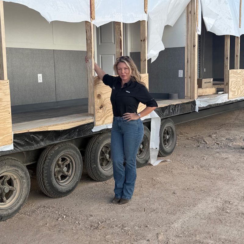 Bethany alongside a BPK modular housing unit en route to deployment