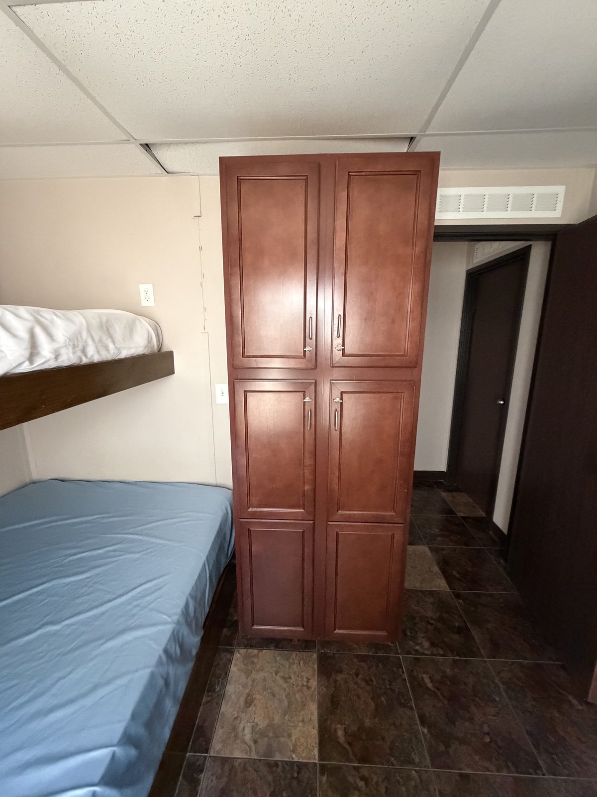 Company Man — bedroom with bunk and storage