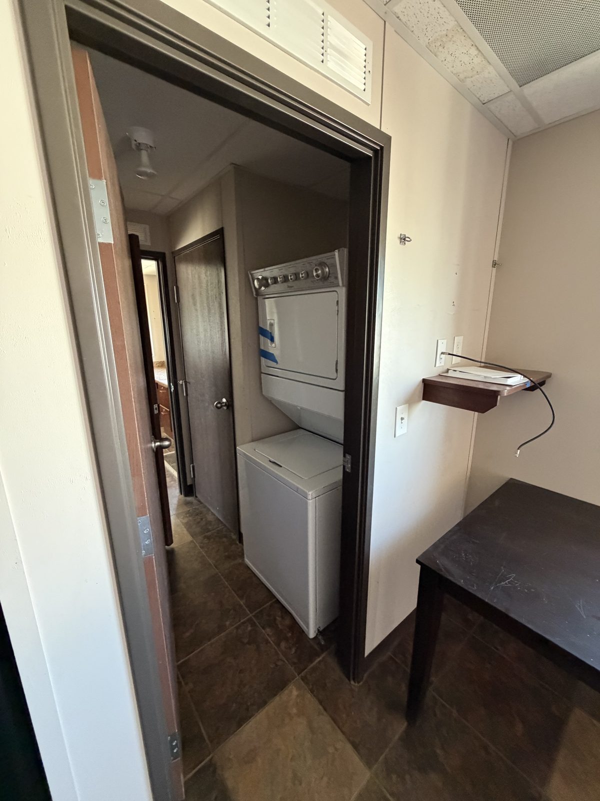 Company Man — utility room with stackable W/D